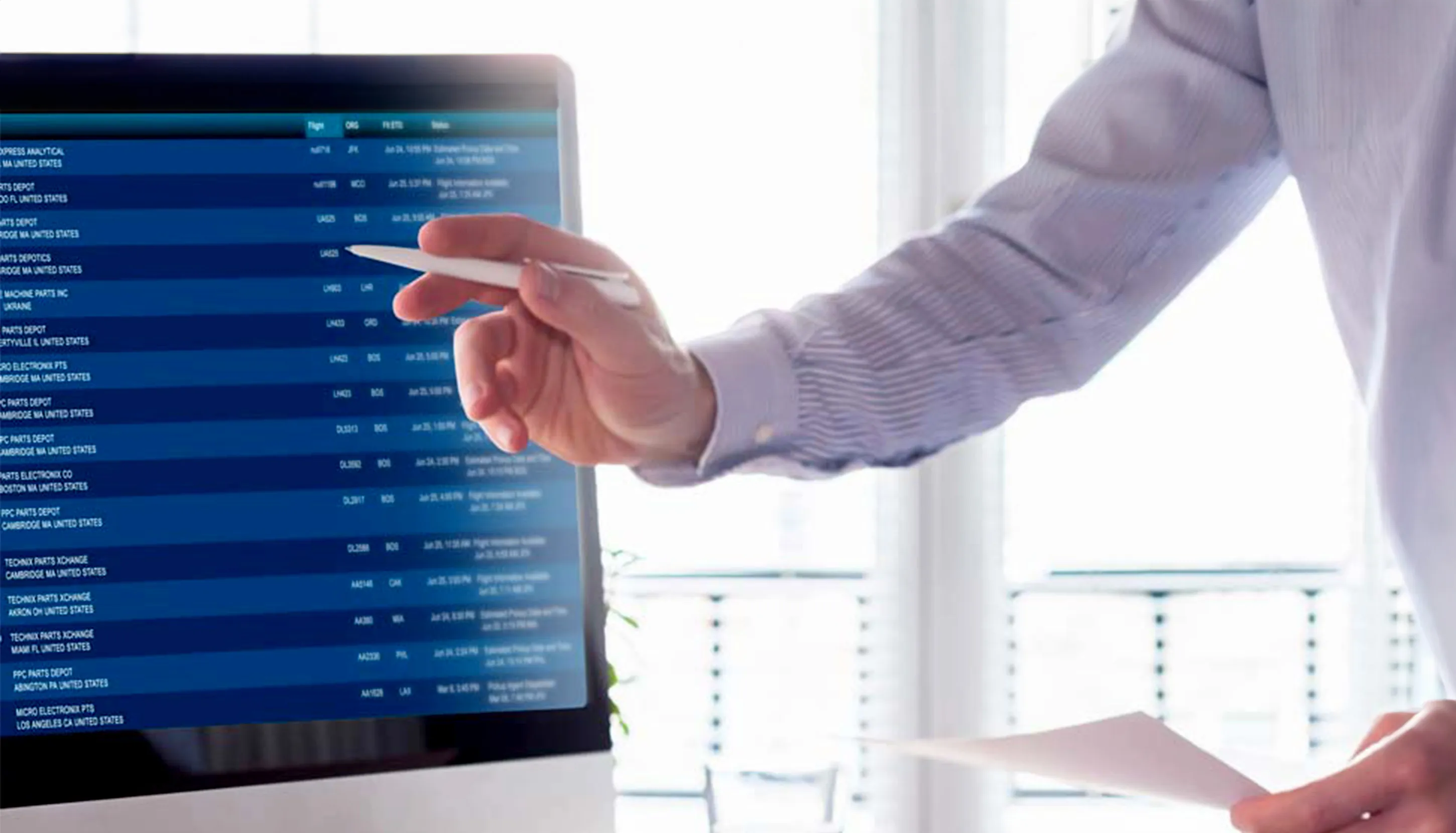 Man pointing with a pen to a computer screen