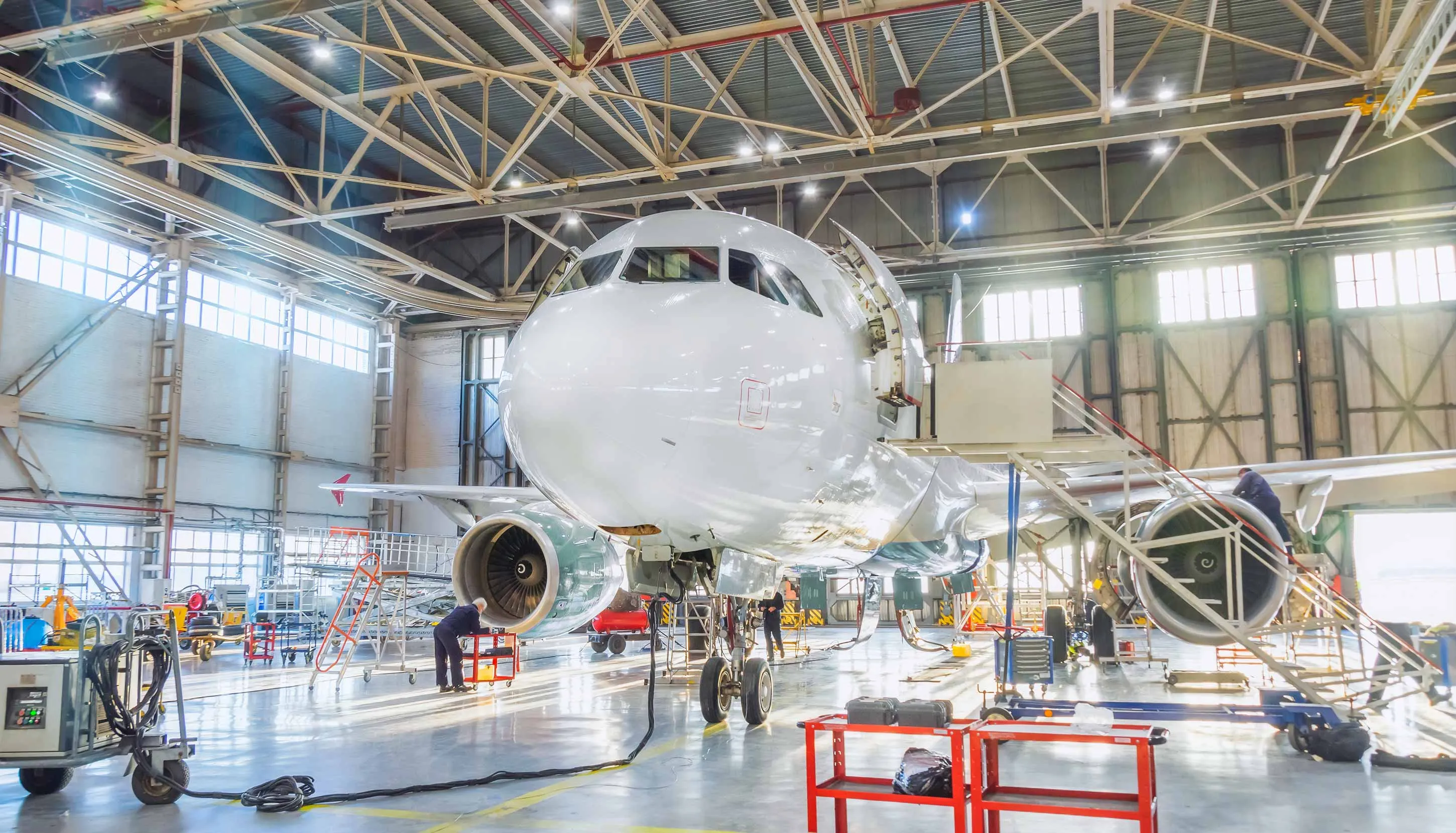 Big white airplane inside the hangar