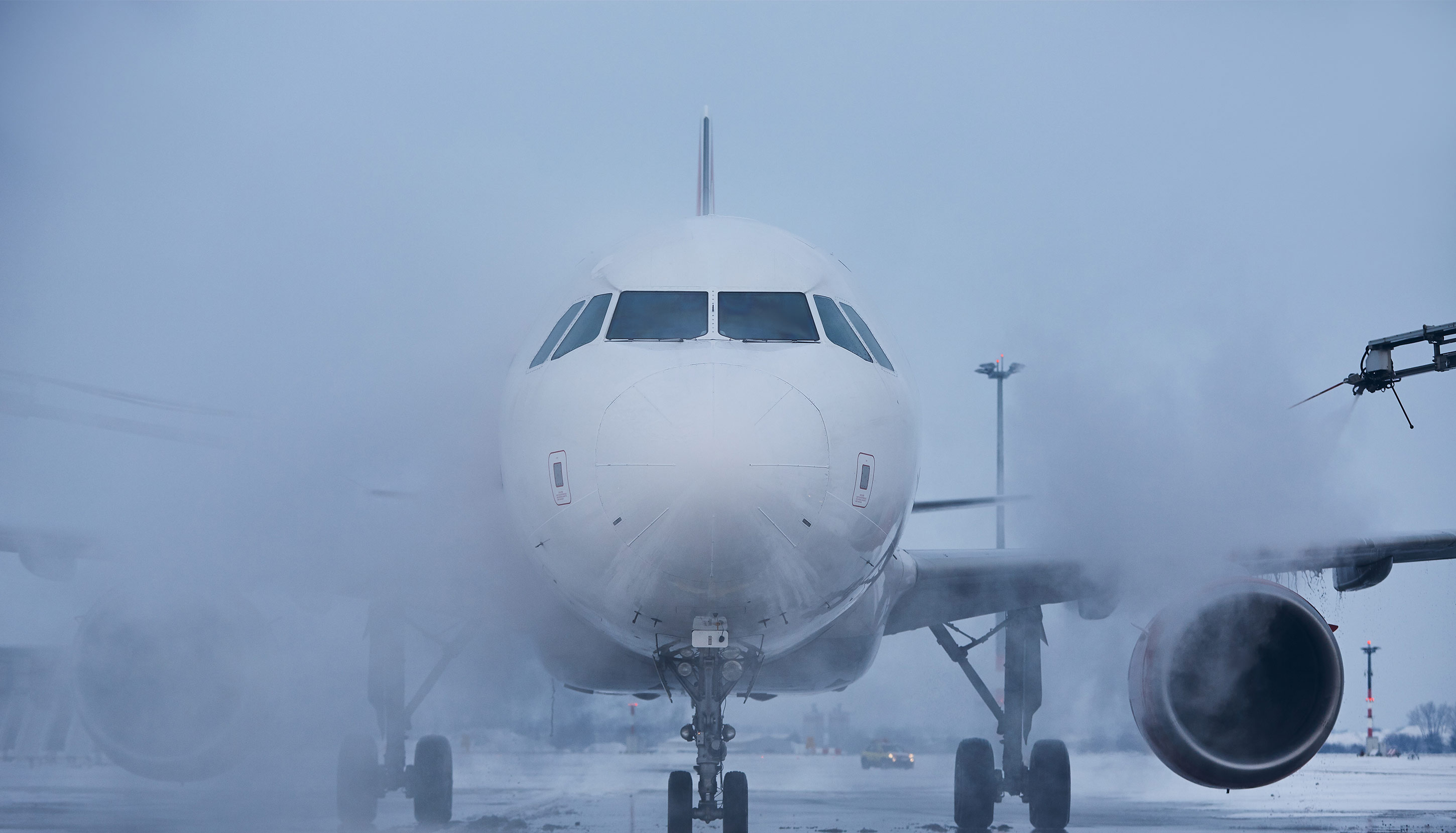 Front view of a big white plane at the airport