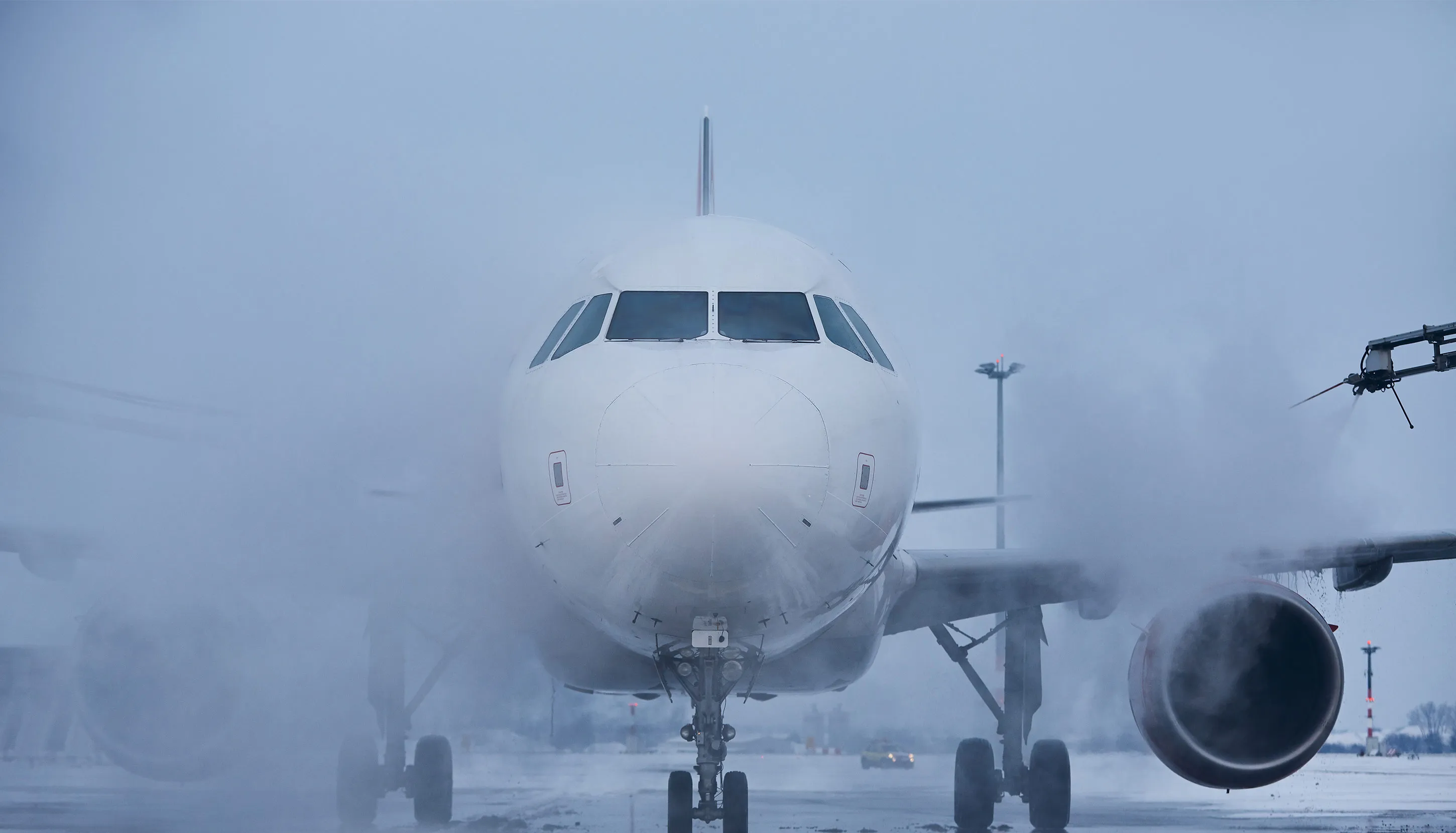 Front view of a big white plane at the airport