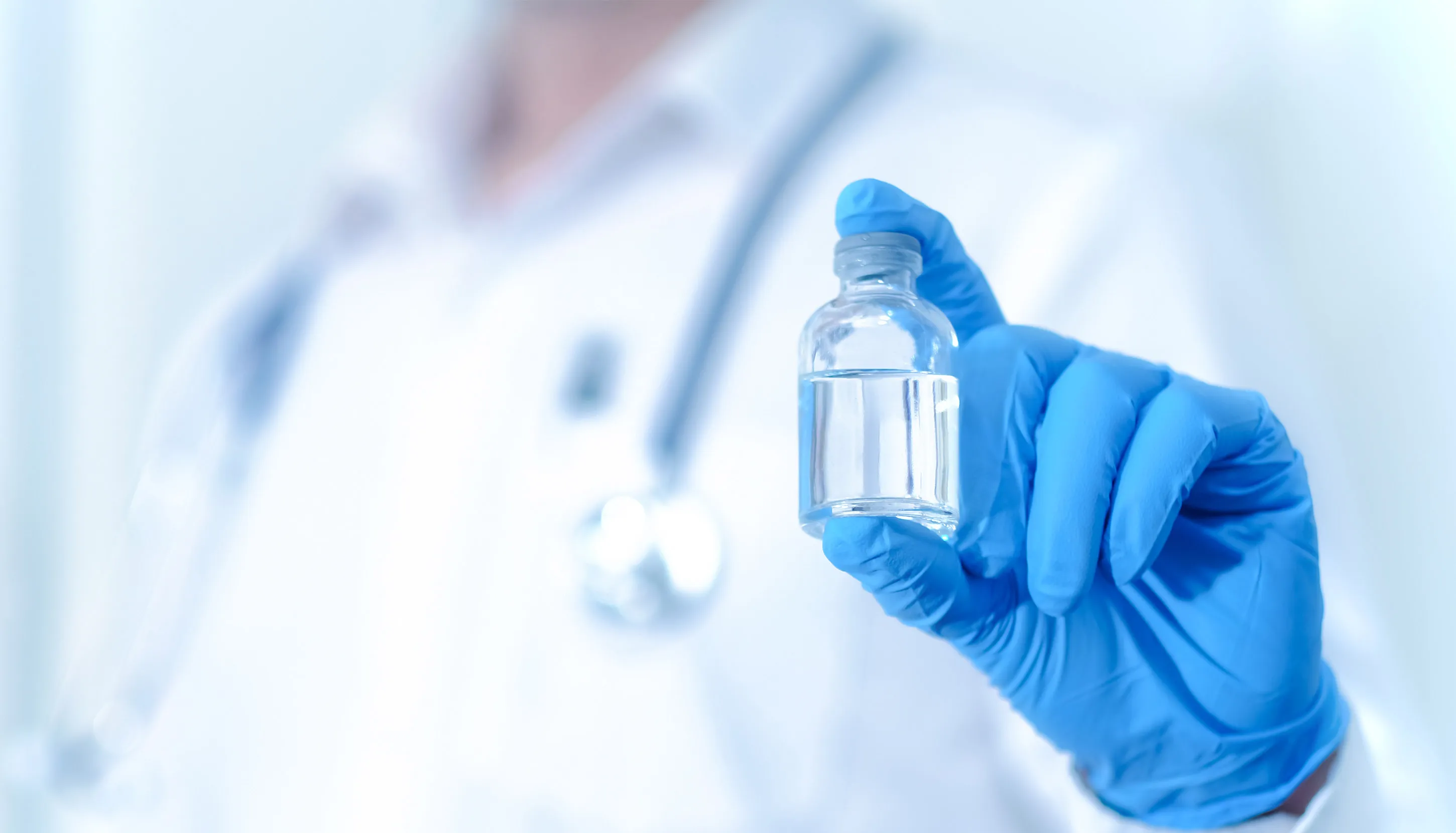 A man holding small glass bottle
