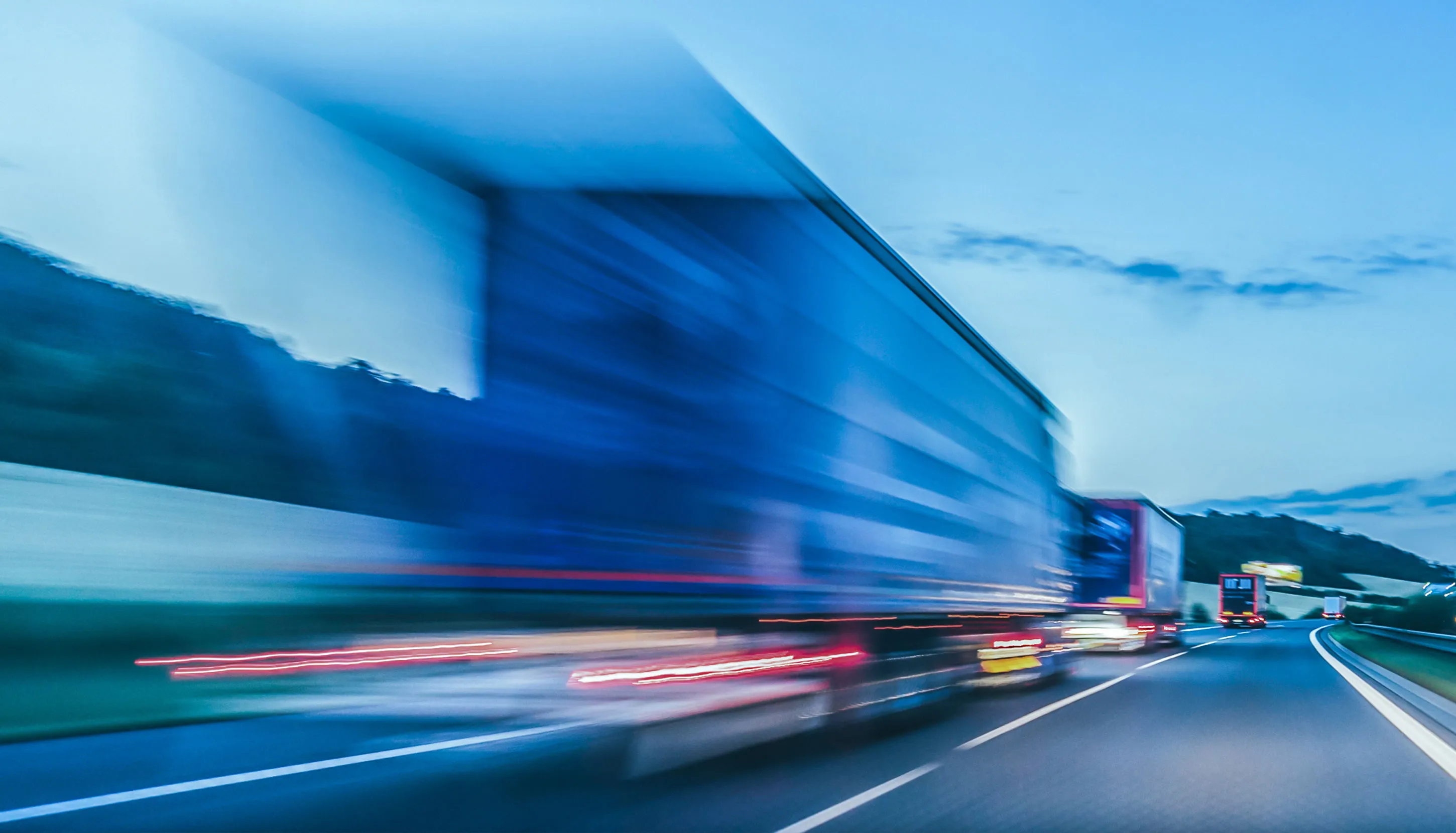 Blue trucks driving on the highway