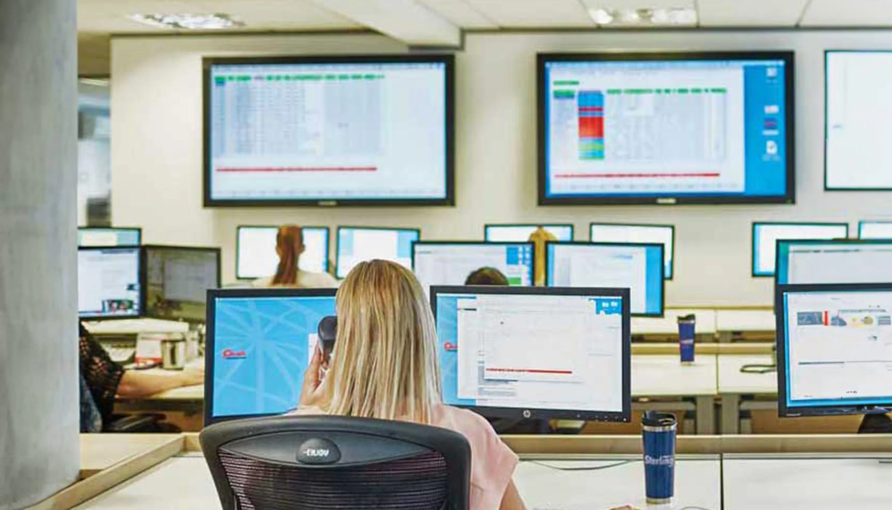 Woman working in a room full of monitors