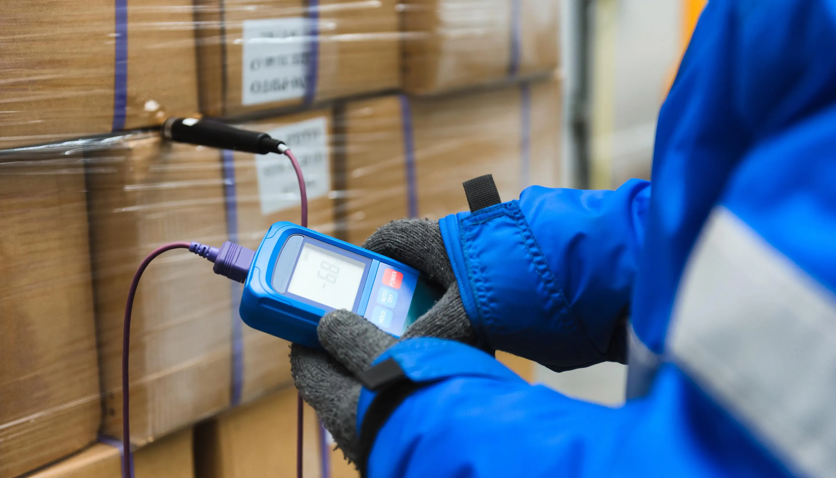A worker in uniform controlling temperature of packages
