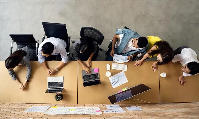 Directly Above Shot Of People Working On computers, at the table