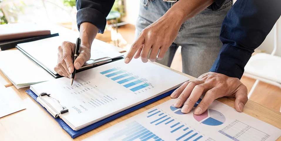 People looking at the chart while writing something down